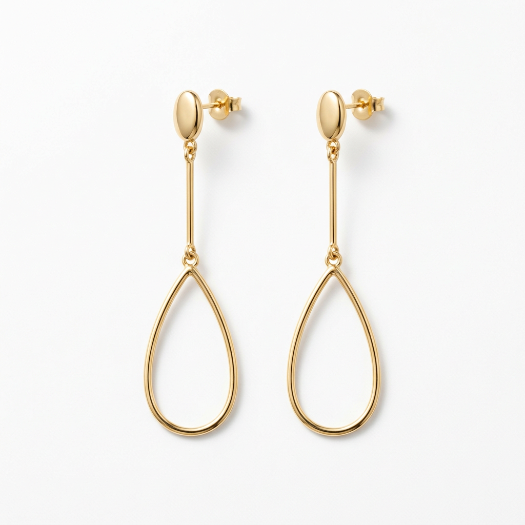 Gold-tone long teardrop earrings on white background