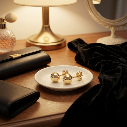 Gold-tone ball stud earrings styled for an evening outfit