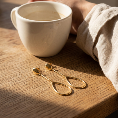 Gold-tone earrings in a cafe setting